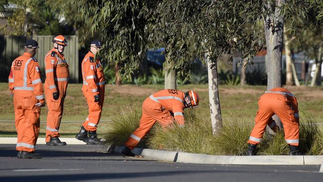 Police and SES search the area. Picture: Andrew Henshaw