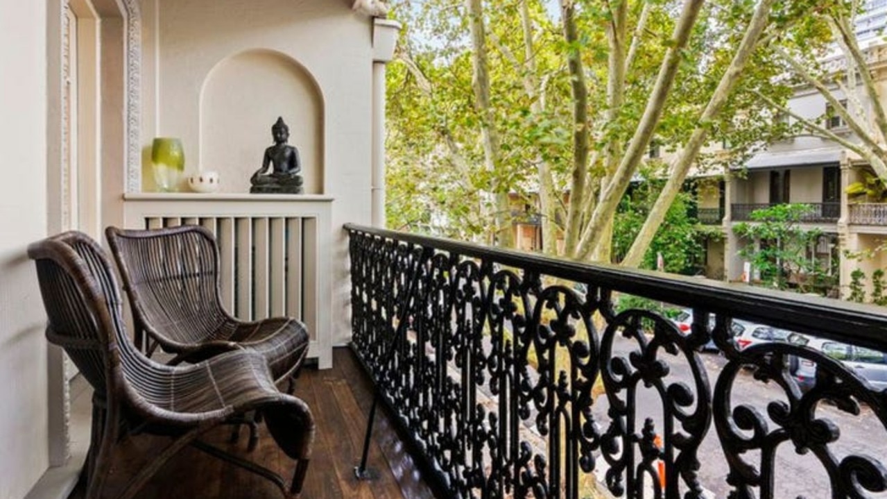 Elegant living rooms open to a sunny balcony.