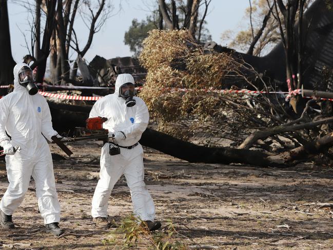 ATSB investigators retrieve the cockpit voice recorder from the crash site. Picture: NSW Police / ATSB