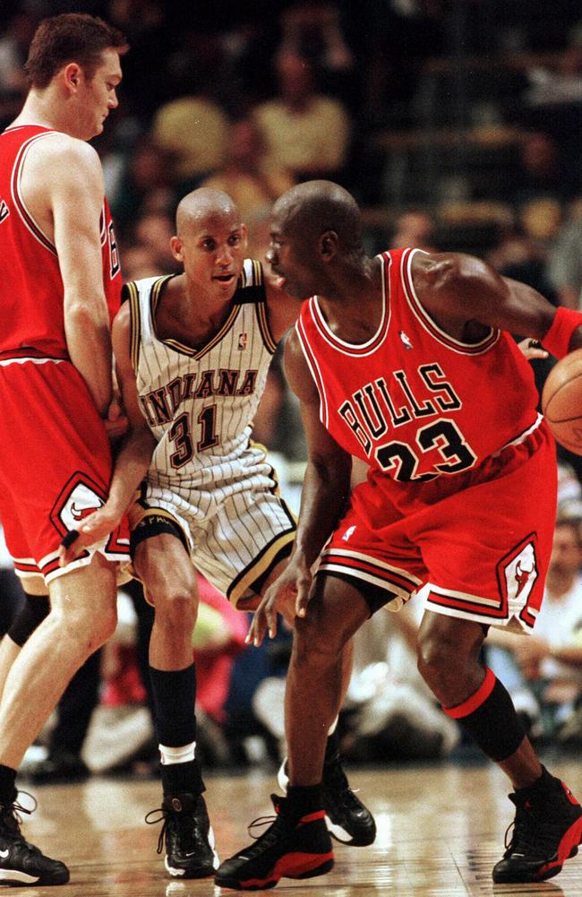 Chicago Bulls’ Luc Longley (left) tries to block Indiana Pacers’ Reggie Miller getting at Michael Jordan during a game in 1998.