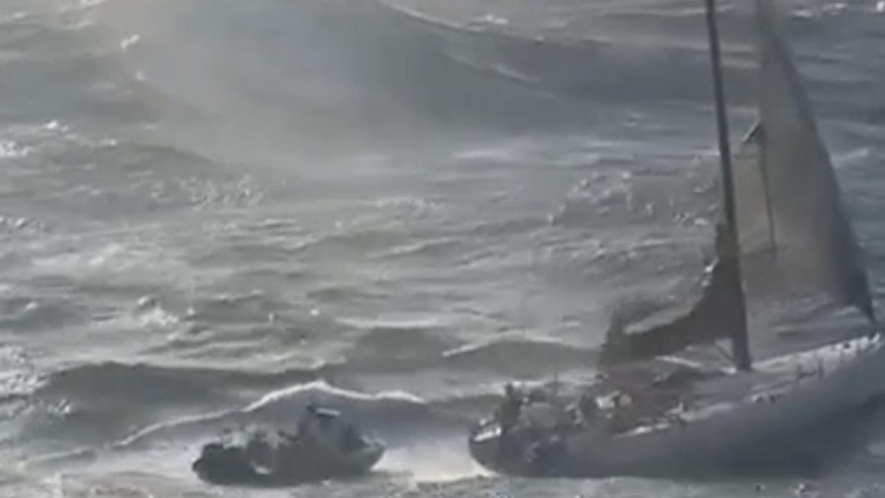 Rescuers reach a yacht with two people onboard in rough seas off the New South Wales south coast on Tuesday morning.
The Australian Maritime Safety Authority said it had received a distress beacon alert about midday on Monday from a vessel 185km east of Nowra. Media reports named the stricken 19-metre yacht as the Spirit of Mateship. Picture: NSW Police