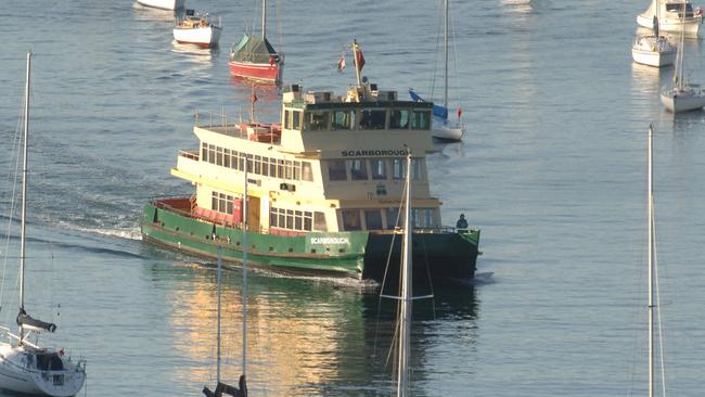 A Sydney ferry negotiates its way through boats at Mosman Bay.