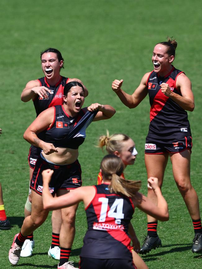 Essendon star Madison Prespakis addresses the body shamers by pointing to her stomach after kicking a goal. Picture: Chris Hyde/Getty Images