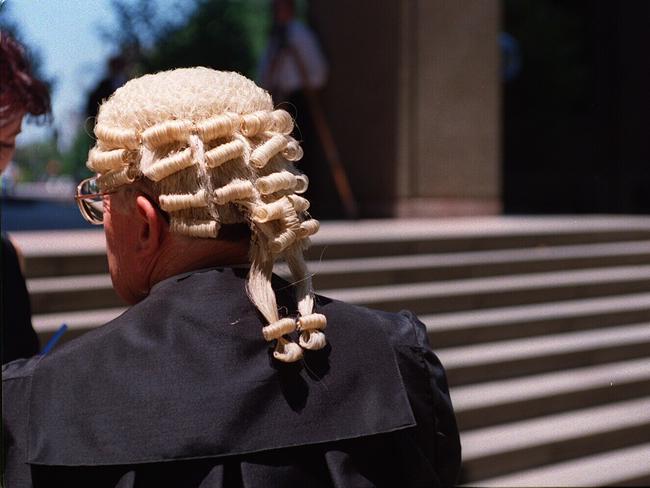 Barrister wearing wig and gown. Court. Law. Justice.