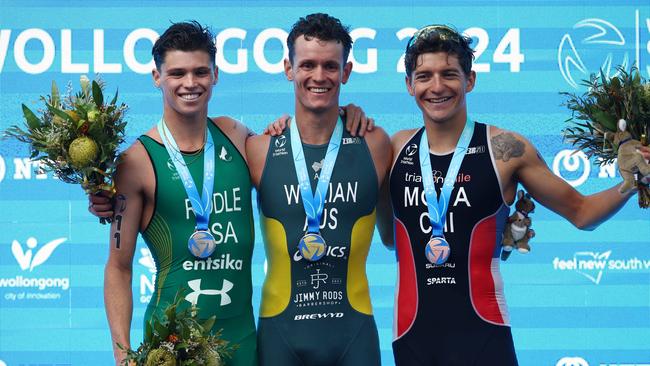 Australia’s Luke Willian (C) stands atop the dais in the Wollongong World Cup. Picture: Con Chronis/AusTriathlon