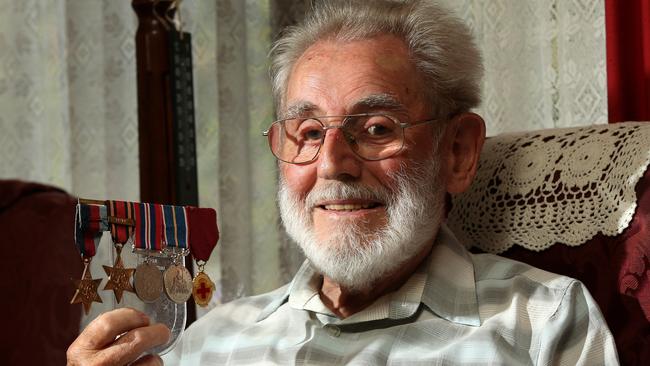 Fred Bottrell with his war medals at home in Ferntree Gully. Picture: Hamish Blair