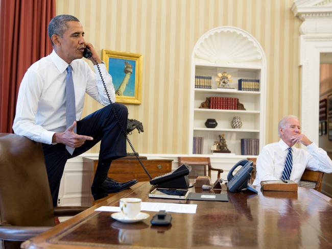President Barack Obama talks on the phone in the Oval Office with Speaker of the House Boehner on August 31, 2013. Vice President Joe Biden listens at right. Picture: Pete Souza/The White House