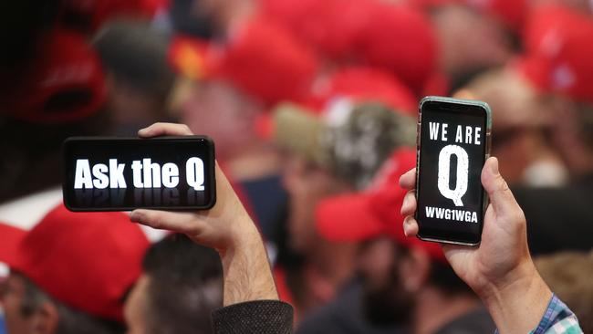 Donald Trump supporters hold up their phones with messages referring to the QAnon conspiracy theory at a campaign rally at Las Vegas Convention Center in Las Vegas. Picture: Getty Images.