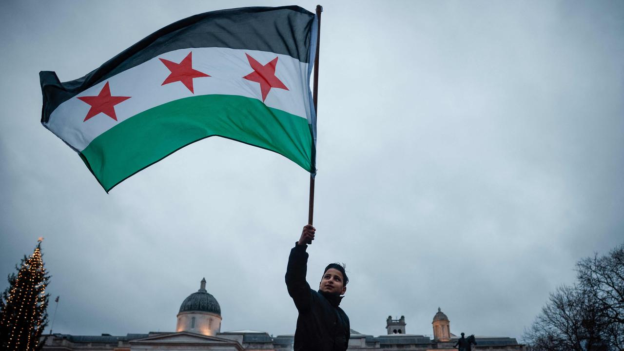 Supporters and members of the Syrian community gathered to celebrate in Trafalgar Square, central London. Picture: Benjamin Cremel/AFP