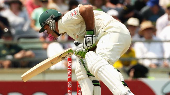 Ricky Ponting after being struck on the elbow by a short delivery from Kemar Roach in 2009. Picture: Mark Dadswell/Getty Images