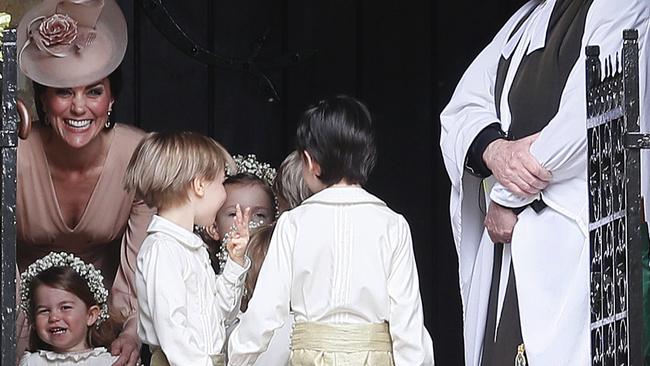 The Duchess of Cambridge laughing with her daughter Princess Charlotte wait for Pippa to arrive. Picture: (AP Photo/Kirsty Wigglesworth, Pool)