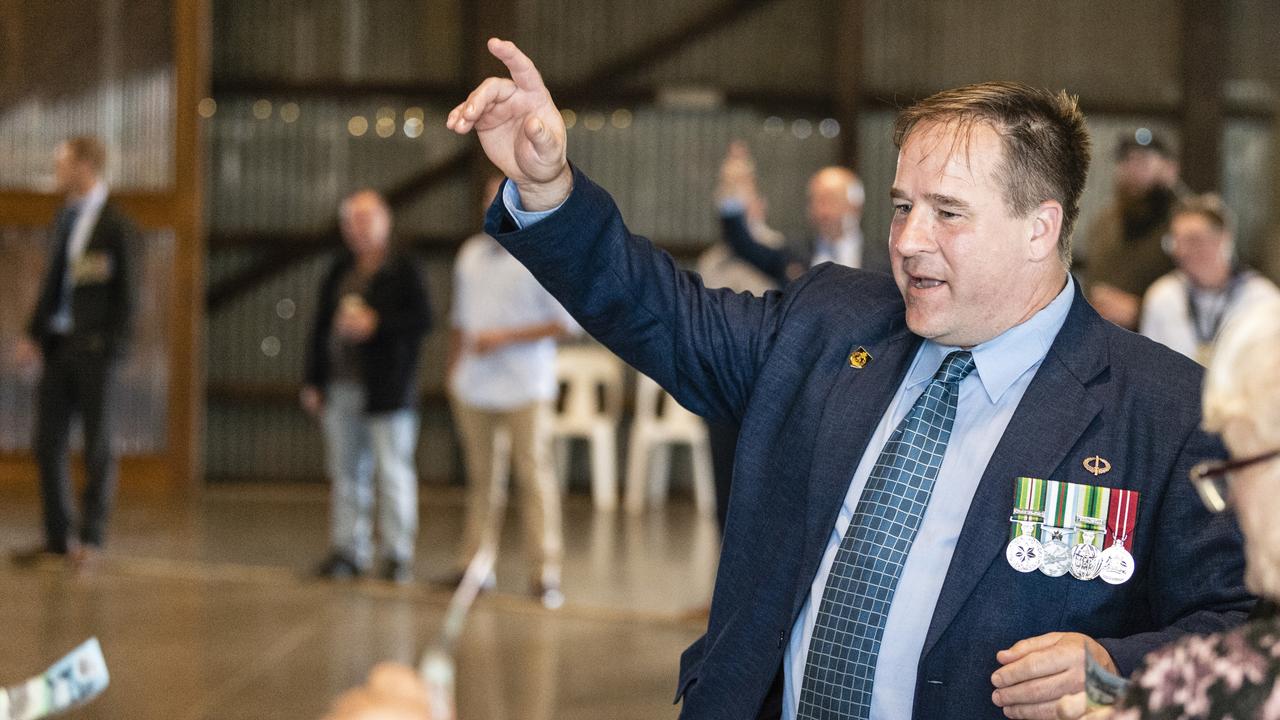 David Kelly organises bets during two-up in the Goods Shed as part of Toowoomba Anzac Day commemorations, Monday, April 25, 2022. Picture: Kevin Farmer