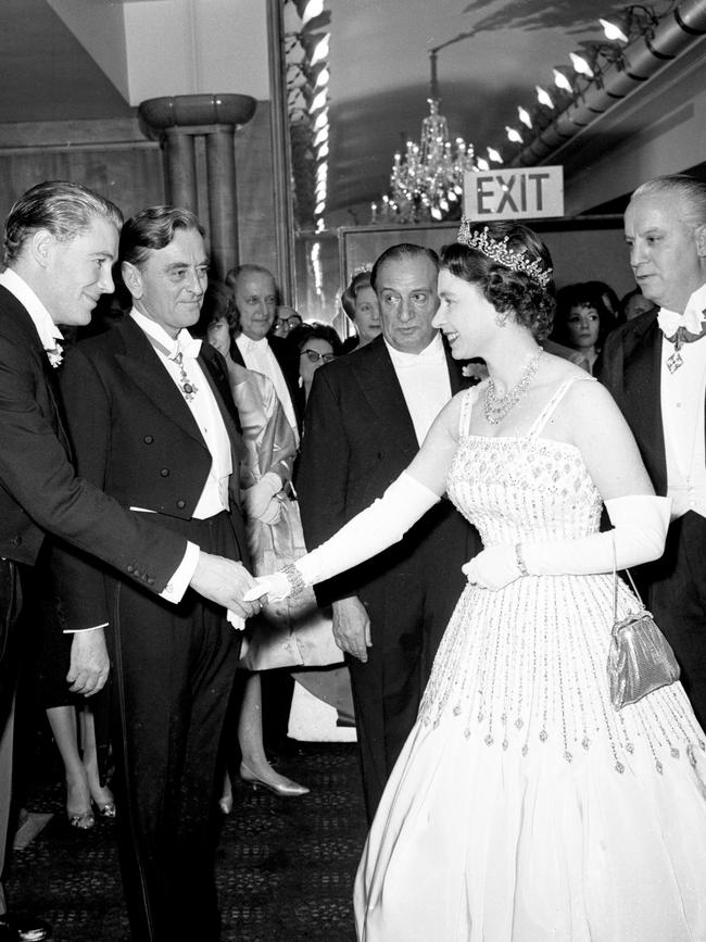 Queen Elizabeth II, in the white silk faille gown later worn by Princess Beatrice, shakes hands with Peter O'Toole when she meets him and other personalities before the world charity premiere of "Lawrence of Arabia' at the Odeon, Leicester Square in 1962 .Picture: Getty