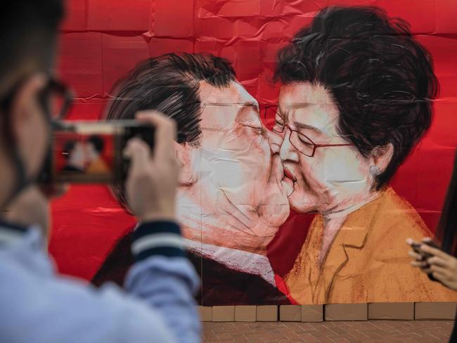 A wall made of cardboard boxes with images of China’s President Xi Jinping and Hong Kong Chief Executive Carrie Lam during an event to celebrate the 30th anniversary of the fall of the Berlin wall in Hong Kong. Picture: AFP