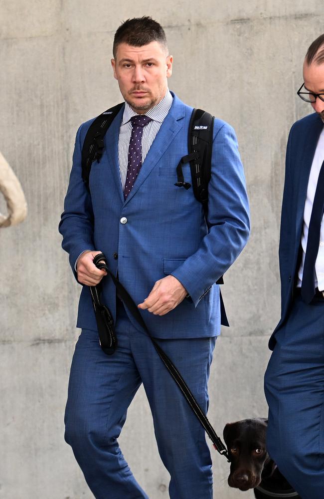 Shaune Irving (walking the dog) following an appearance at Brisbane’s District Court. Picture: NCA Newswire / Dan Peled