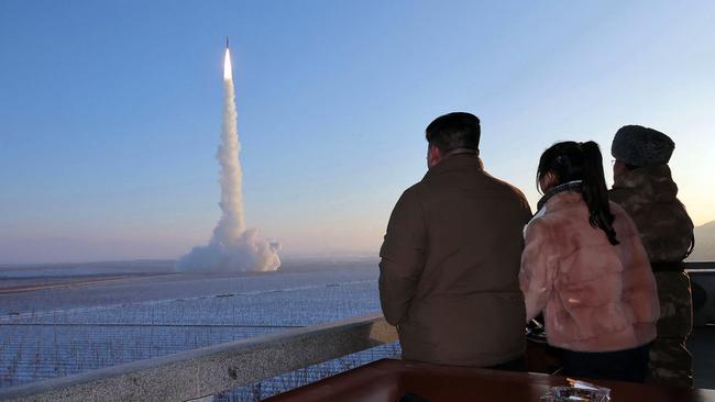 North Korean leader Kim Jong-un (L) and his daughter watch the test launch of an intercontinental ballistic missile at an undisclosed location in North Korea. Picture: KCNA/AFP