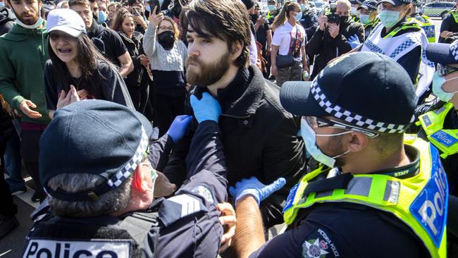 Police clash with protesters at a Melbourne Freedom Walk at Queen Victoria Market on Sunday. Picture: NCA NewsWire / David Geraghty