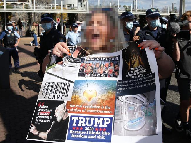 A Sydney "Freedom Day" protester in September 2020 holds up a sign bearing QAnon’s slogan. Picture: David Swift