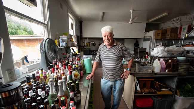 Terry Gordon, Chairman of Camden Sports Club chairman Terry Gordon, with bar stock saved from spoiling in the floods. Picture: Julian Andrews