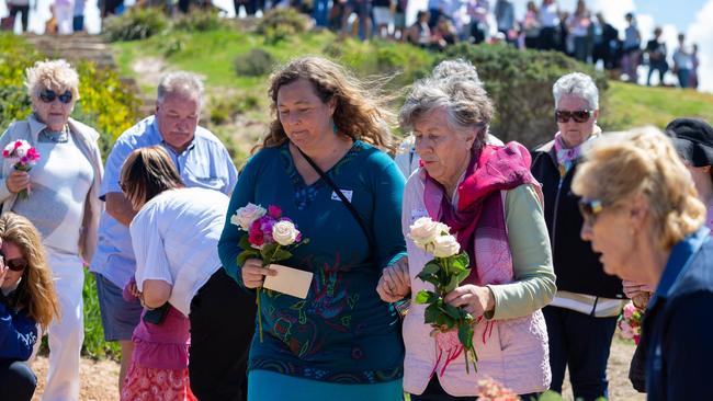 Shanelle Dawson and Pat Jenkins lay flowers. Walk for Lyn Dawson at Long Reef Surf Club in Sydney NSW. Lyn went missing in 1982, and her body has never been found. Sunday 30th September 2018. (AAP Image/Jordan Shields)