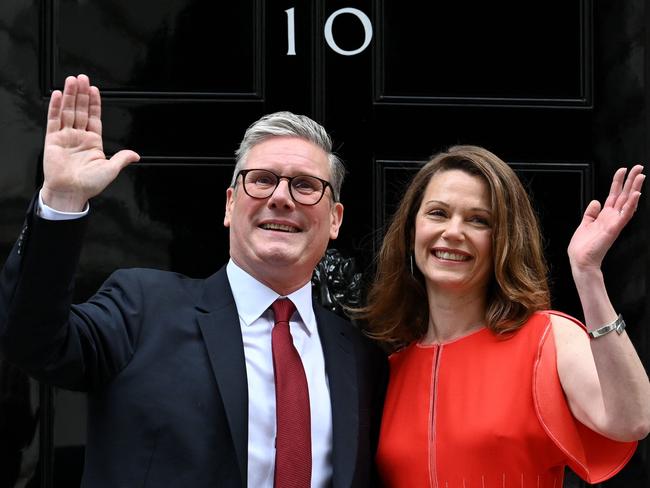 Britain's incoming Prime Minister Keir Starmer and leader of the Labour Party, and his wife Victoria wave as they pose on the steps of 10 Downing Street in London on July 5, 2024, a day after Britain held a general election. Starmer became Britain's new prime minister, as his centre-left opposition Labour party swept to a landslide general election victory, ending 14 years of right-wing Conservative rule. (Photo by JUSTIN TALLIS / AFP)