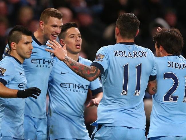 MANCHESTER, ENGLAND - FEBRUARY 21: Edin Dzeko of Manchester City celebrates scoring their third goal with team mates during the Barclays Premier League match between Manchester City and Newcastle United at Etihad Stadium on February 21, 2015 in Manchester, England. (Photo by Clive Brunskill/Getty Images)