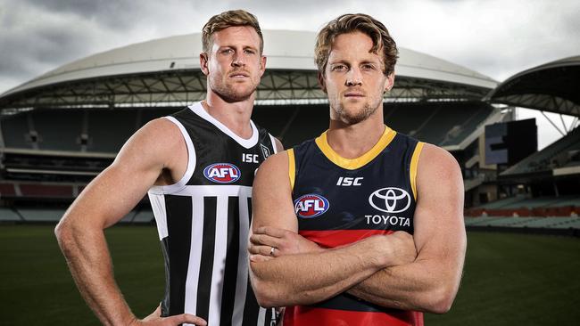 Port Adelaide captain Tom Jonas, pictured alongside Adelaide skipper Rory Sloane, wearing the prison-bar guernsey that the club is weighing up whether to wear in the June 13 Showdown. Picture: Sarah Reed