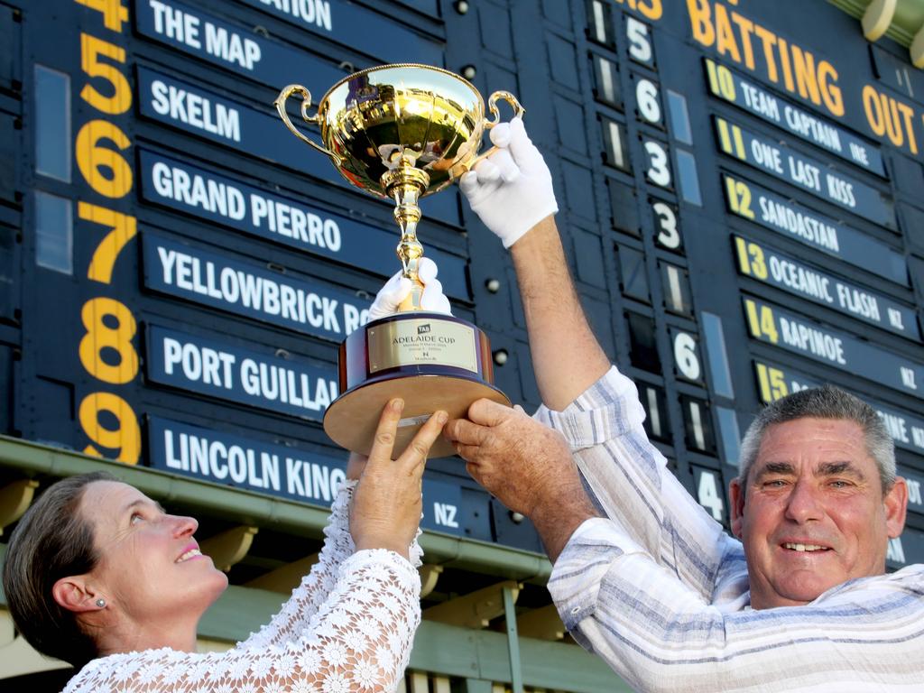 Adelaide Cup Barrier Draw on the Adelaide Oval Scoreboard. Joint trainers of ÃThe MapÃ, the favourite in  the Adelaide Cup, with the cup in front of the barrier draw on the Adelaide scoreboard. 8 March 2024. Pic. Dean Martin