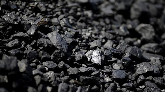 FILE - In this May 22, 2014, file photo, sunlight reflects off of a chunk of coal at Dominion Terminal Associates' coal terminal in Newport News, Va. The Trump administration is considering using West Coast military bases or other federal properties as transit points for shipments of U.S. coal and natural gas to Asia. (AP Photo/Patrick Semansky, File)