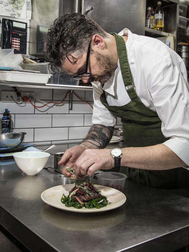 Jock Zonfrillo working his magic in the kitchen at Orana, plating a beef main and a cherry desert. Picture: Mike Burton