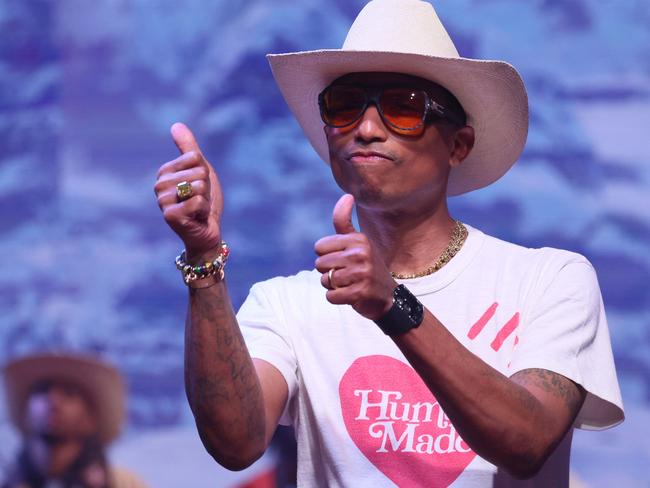 US rapper, artist and fashion designer Pharrell Williams gives the thumbs up to the western trend. Picture: AFP