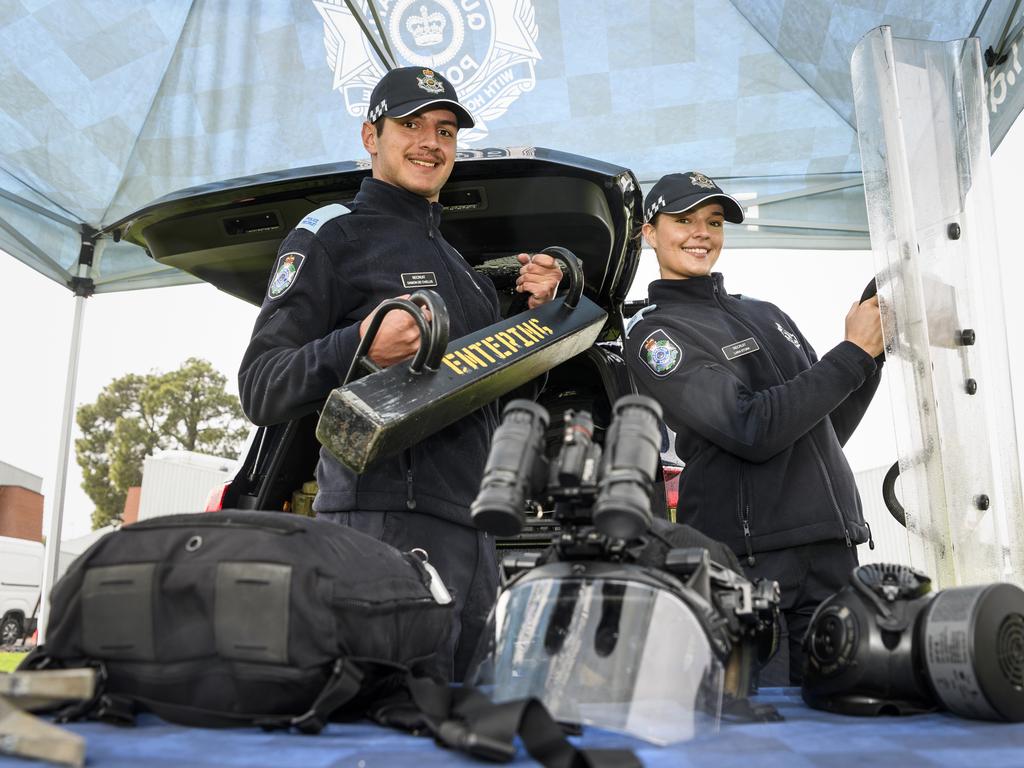 Police recruits Damon De Chellis and Lara Stork with equipment from the Public Safety Response Team's display at the Queensland Police Community Safety and Career Expo on the TAFE oval, Saturday, May 31, 2025. Picture: Kevin Farmer