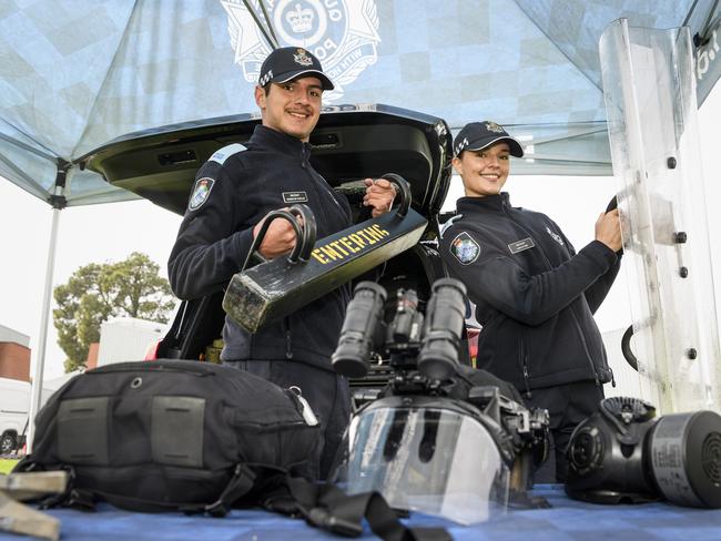 Police recruits Damon De Chellis and Lara Stork with equipment from the Public Safety Response Team's display at the Queensland Police Community Safety and Career Expo on the TAFE oval, Saturday, May 31, 2025. Picture: Kevin Farmer