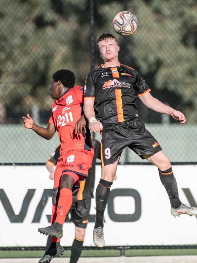 Aladin Irabona and Matthew Dawbar contest the ball during the Adelaide United versus MetroStars match on Sunday. Picture: AAP Image/ Morgan Sette