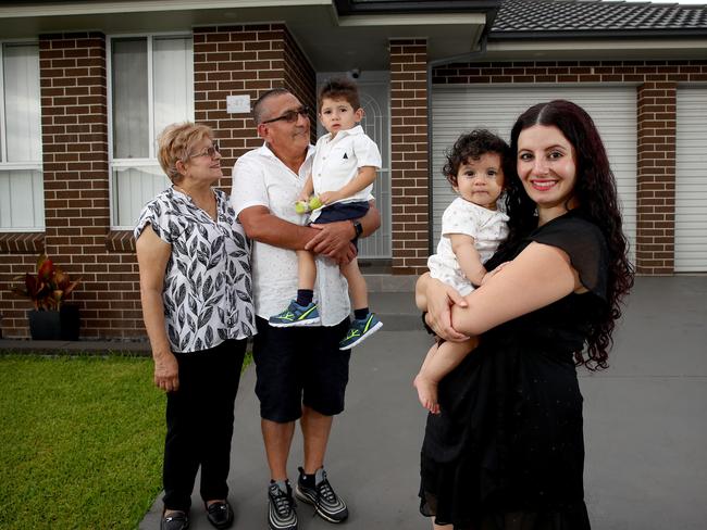 WEEKEND TELEGRAPHS SPECIAL. MUST TALK WITH PIC ED JEFF DARMANIN BEFORE PUBLISHING.   SATURDAY TELEGRAPH - Mary Jekki-Acosta pictured with her children Ezekiel 2 and Jasmine 7 months and parents-in-law Francisco Acosta and Maria Elena Montaez at home in Middleton Grange. Real estate experts are noticing a trend in young Sydney house hunters getting help from the 'bank of mum and dad' to help them get into the market. Picture: Toby Zerna