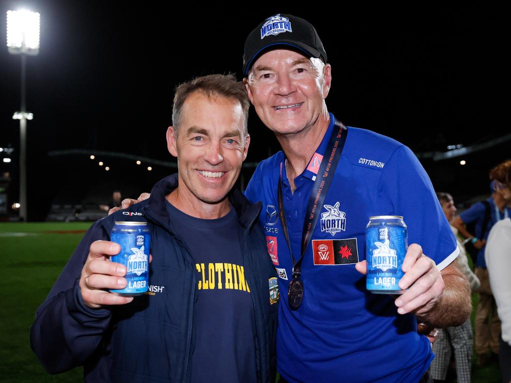 Darren Crocker with Alastair Clarkson sharing a drink after the grand final win. Picture: Getty Images