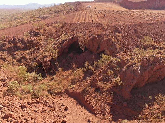 This handout photo taken on May 15, 2020 and released by the PKKP Aboriginal Corporation and recieved by AFP on May 27, 2020 shows Juukan Gorge in Western Australia -- one of the earliest known sites occupied by Aboriginals in Australia. - Anglo-Australian mining giant Rio Tinto has admitted damaging ancient Aboriginal rock shelters in the remote Pilbara region -- blasting near the 46,000-year-old heritage site to expand an iron ore mine. (Photo by Handout / PKKP Aboriginal Corporation / AFP)