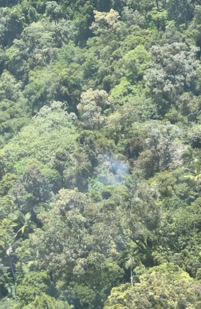 Smoke rising from the thick tree coverage of a mountain range north of Okuloo and Netherdale where it is understood a plane crashed on Saturday, October 28, 2023. Picture: RACQ CQ Rescue