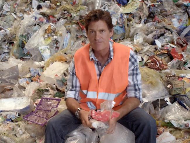 Craig Leeson sits atop of mountain of plastic waste in a scene from A Plastic Ocean. Picture: Supplied.