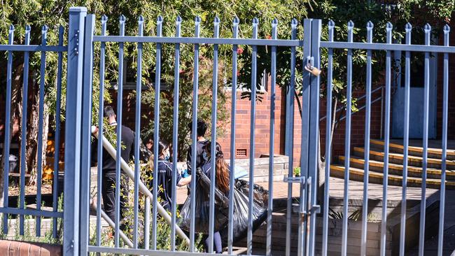 Cleaning crews are seen at St Pauls Catholic College in western Sydneyearlier this week. Picture: NCA NewsWire/Flavio Brancaleone