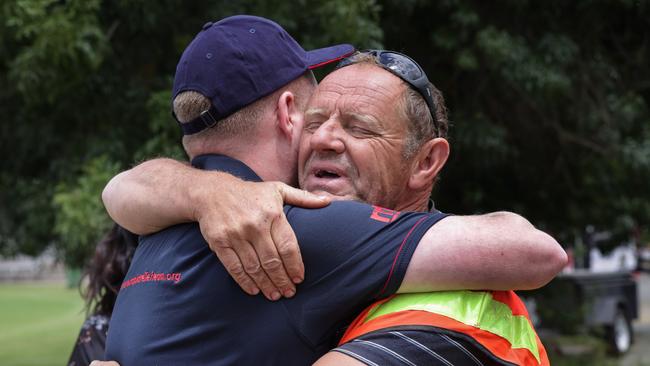 Grateful Kerang cattle farmer Allan Matthews hugs Rapid Relief Team member Nathan Pederick for a trailer full of lifesaving hay for cattle that survived the flood. Picture: David Caird