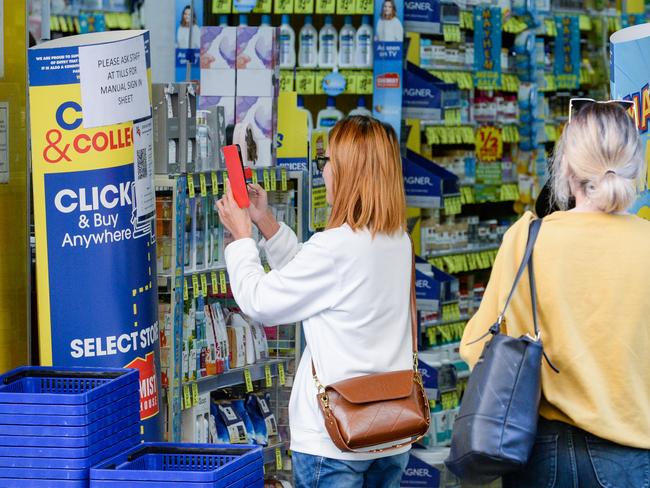 People checking into Chemist Warehouse in Gawler Place via QR code. Picture: NCA NewsWire / Brenton Edwards