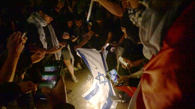 Protesters burn the Israeli flag on the forecourt of The Sydney Opera House in Sydney on October 9, two days after the October 7 attack. Picture: NCA NewsWire / Jeremy Piper