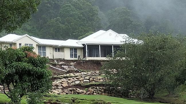 Police at Crest Hill Drive in Wongawallan after a land slip following heavy rain put a house in danger of collapse. Picture: Jerad Williams.