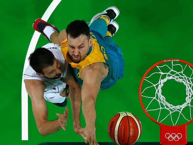 Andrew Bogut defends Stefan Bircevic of Serbia.