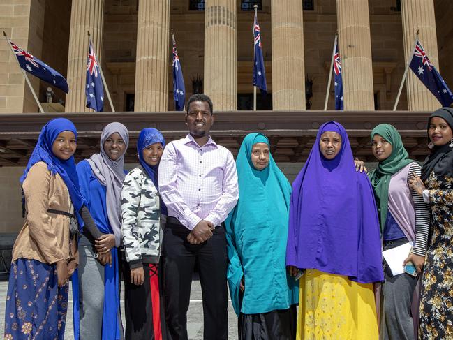 Mohamed and his family ltr Fartuh, Warsar, Nima, Safia, Nurio, Sadia and Fardowso poses for a photograph outside of Brisbane Town Hall. Today they received their Australian Citizenship. Picture: AAP