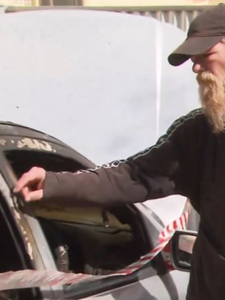 David Wallace with his car, which was torched. Picture: 7NEWS