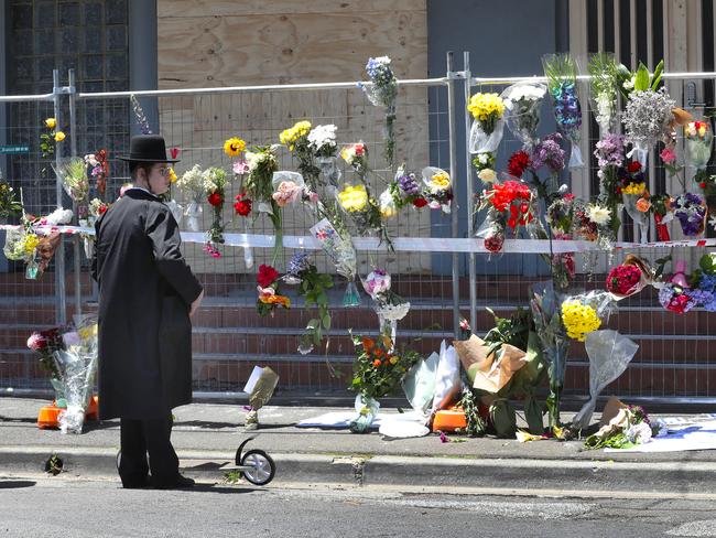 People lay flowers at the  Adass Israel Synagogue in Ripponlea that was fire bombed. Sunday, December 8. 2024. Picture: David Crosling