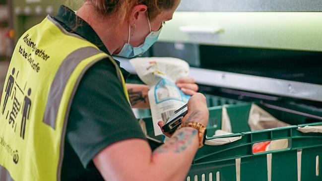 A Woolworths workers packs a delivery. Picture: Supplied