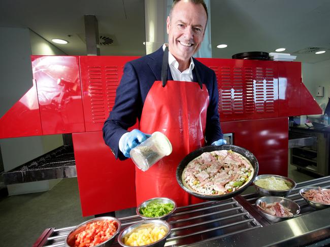Pizza supremo ... Don Meij, CEO of Domino's Austarlia, putting the finishing touches on a Supreme Pizza. Photo: Steve Pohlner